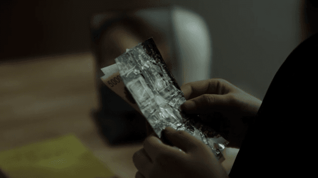 봉투에서 사진, 돈, 편지를 꺼내는 손