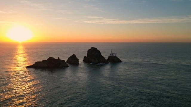 Sunset over the ocean with rocky islets