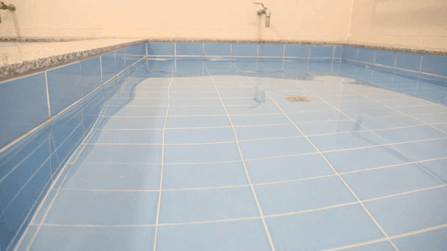 Bathroom with blue tiles and water