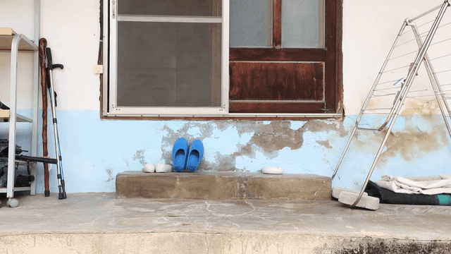 Front porch with blue slippers and drying rack