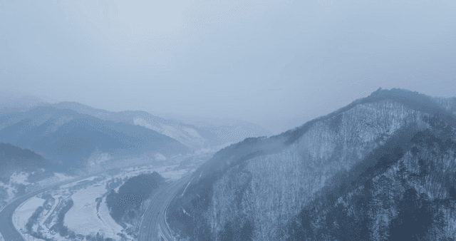 Snow-covered mountains and winding road