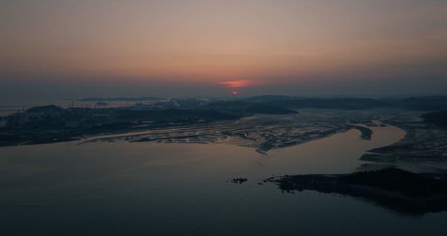 Sunset over Serene Coastal Landscape