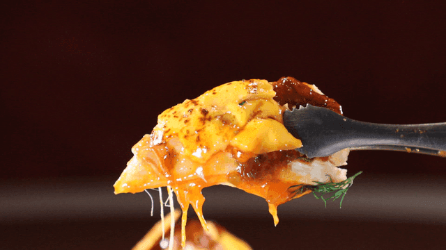Cheese chicken and sauce on tongs
