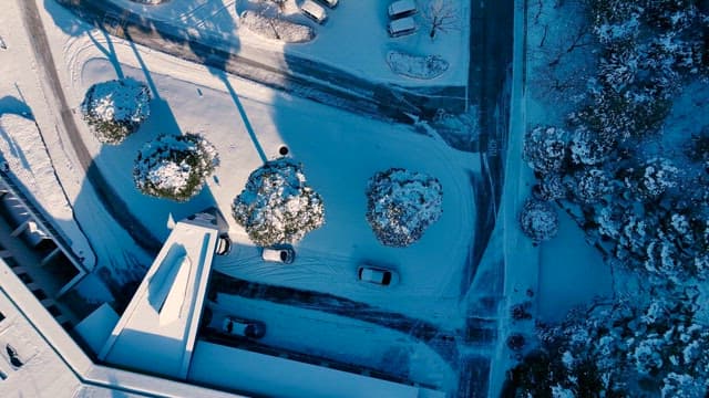 Snowy Landscape with Roads and Parked Cars