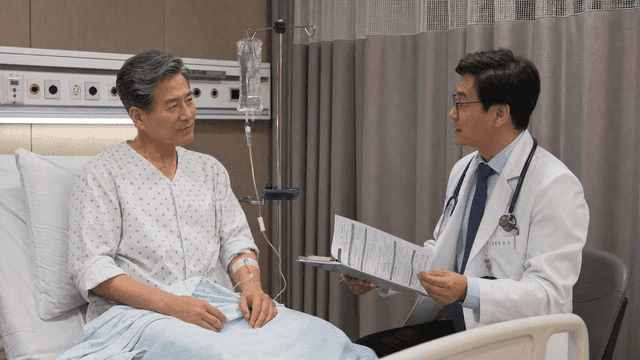 Doctor communicating with elderly male patient receiving IV drip in hospital room