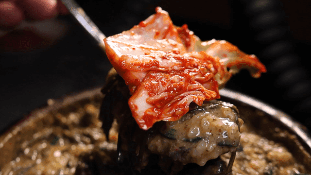 추어탕과 김치가 가득 얹어진 숟가락