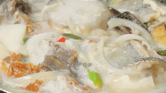 Ladle stirring boiling rockfish stew
