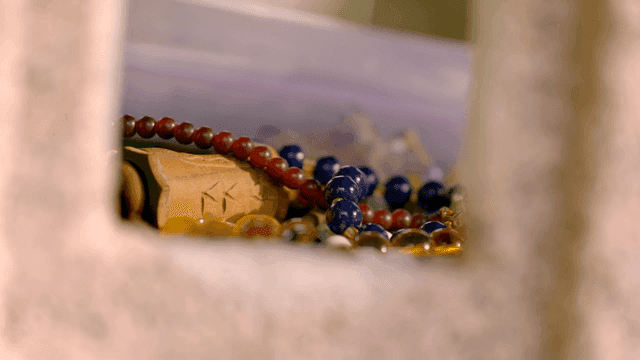 Colorful Buddhist prayer beads and wood carvings