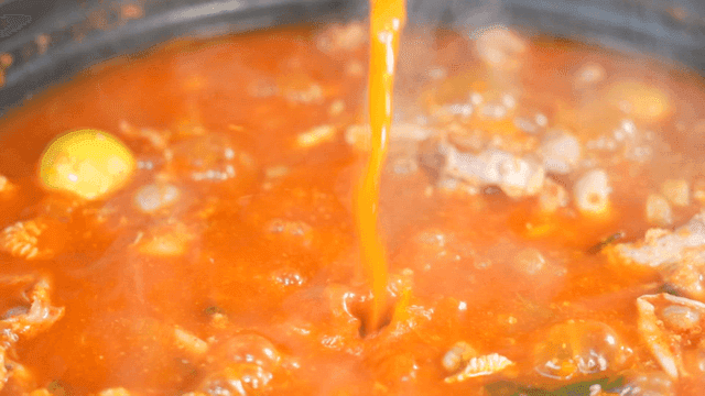 Spicy chicken offal soup with rich broth boiling