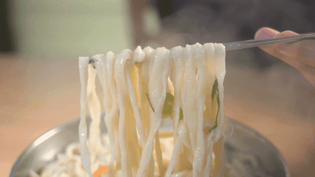 Handmade noodle soup steaming in pot
