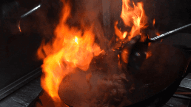 Wok with soaring flames