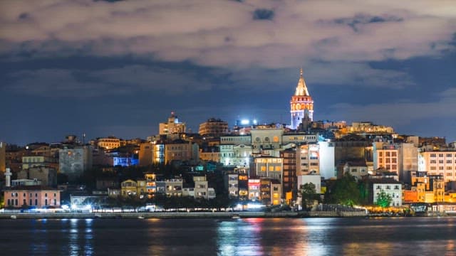 Coastal Cityscape at Dusk with Illuminated Buildings