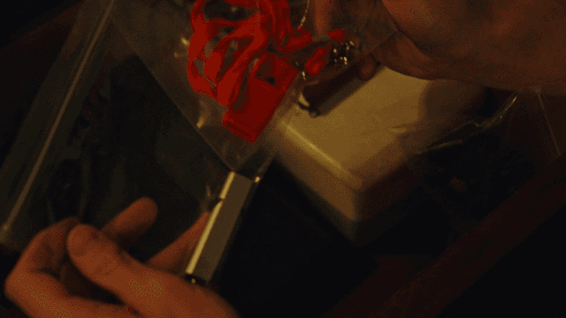 Hands holding a red whistle in a drawer