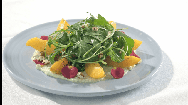 Fresh salad with peaches and greens