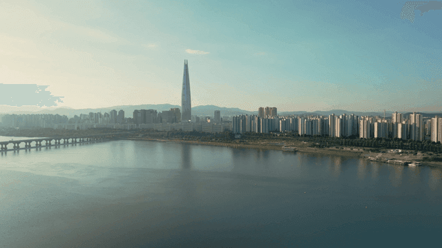 A city skyline with a river and skyscrapers