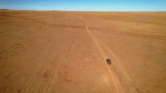 Vehicle Traveling on Remote Desert Road