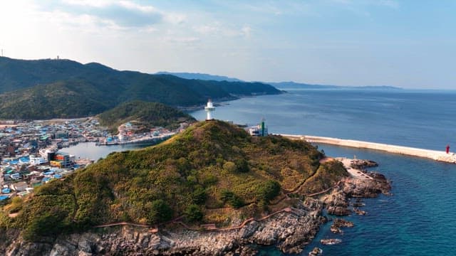 해안 언덕 위의 등대와 마을