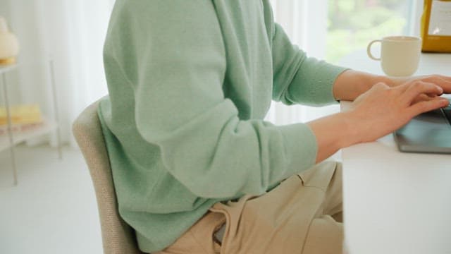 Man using laptop on the white table