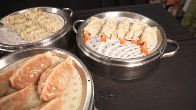 Various types of dumplings on steamers
