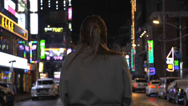 Back view of woman on lively city street