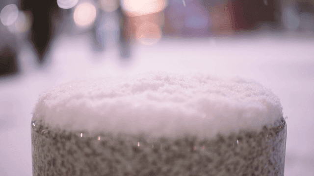 Snow piled up on curb at night