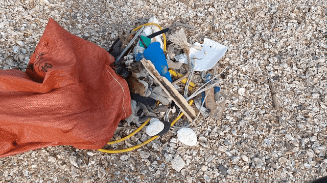 Litter scattered on a rocky beach