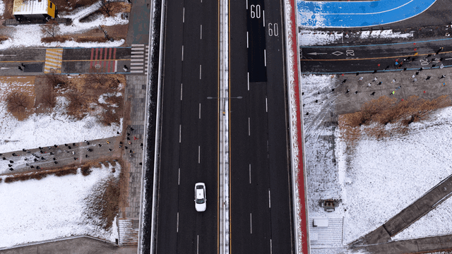 People running under snow-covered road