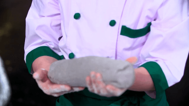 Chef holding starch dough in a large bowl