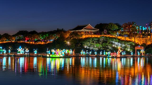 Colorful lanterns floating on the river below Jinjuseong Fortress