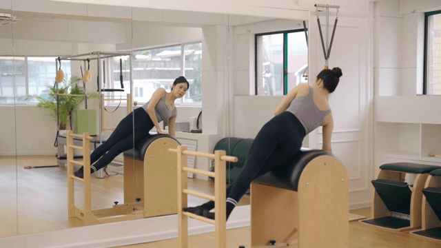 Woman exercising on a pilates barrel