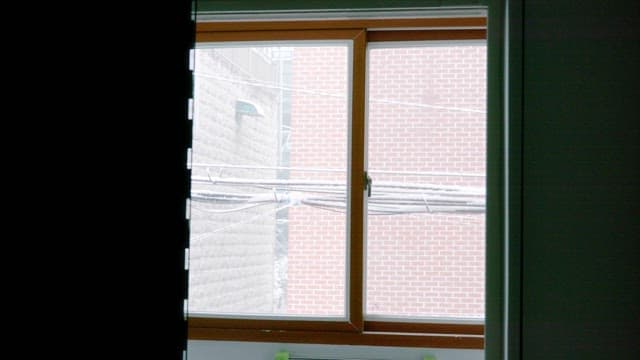 Snow falling outside the window on a winter day