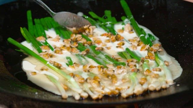 Korean style pajeon with green onions and fresh clams