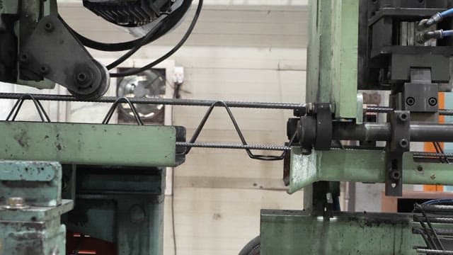 Metal rods being processed in a factory