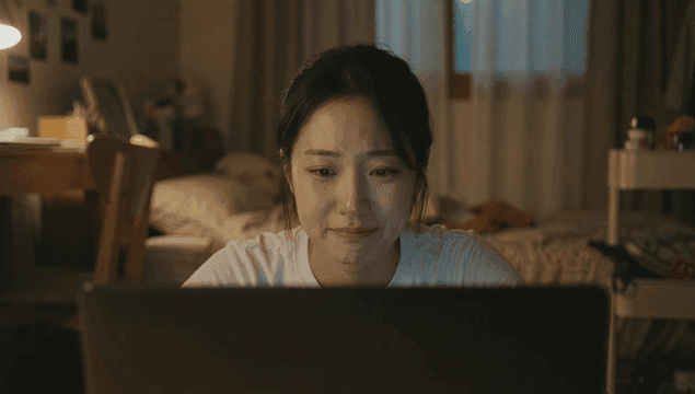 Woman crying in front of a laptop