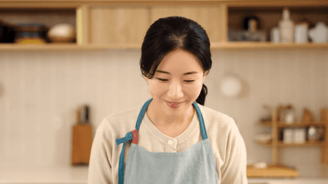 Woman smiling in a kitchen