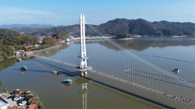 Suspension bridge over a calm lake