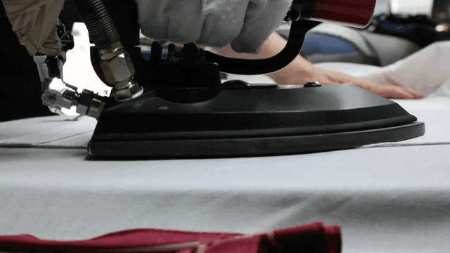 Fabric being ironed in a laundry shop
