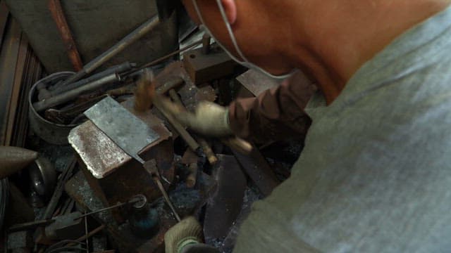 Craftsman forging a metal blade