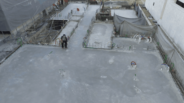 Construction site with workers on concrete