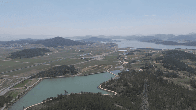 Wide farmland with mountains and rivers