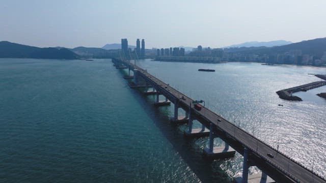 Gwangan Bridge scenery with many cars passing over the blue sea