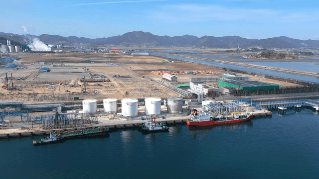 Industrial complex by the sea with ships