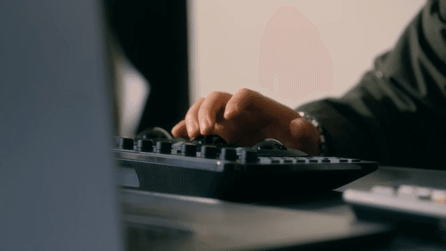 Hands operating a video editing console