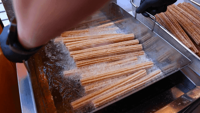 Churros being fried in hot oil