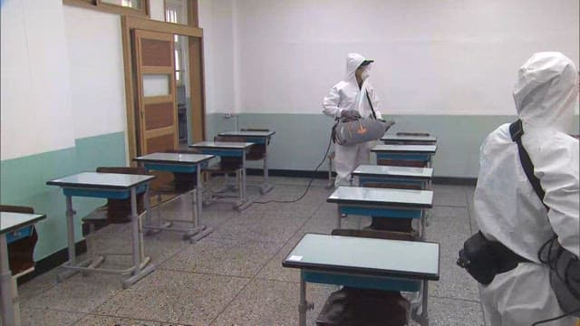 Sanitizing an Empty Classroom with Disinfectant