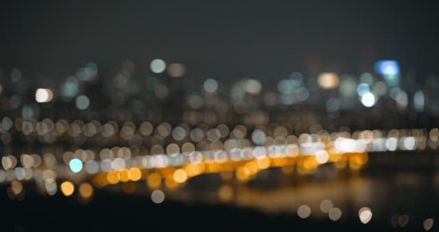 City skyline and illuminated bridge at night