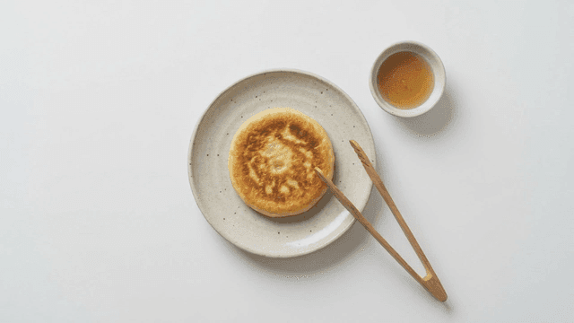 Hotteok placed on plate with honey