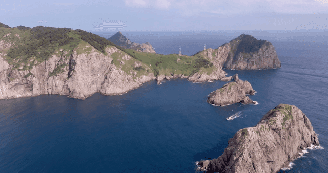 Rocky island with lush greenery and ocean
