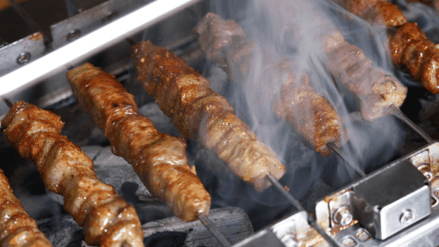 Lamb skewers grilled over charcoal