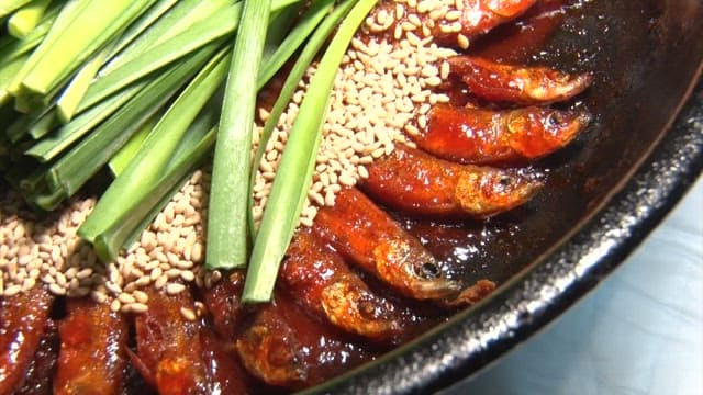 Glazed deep-fried minnows in a ceramic bowl